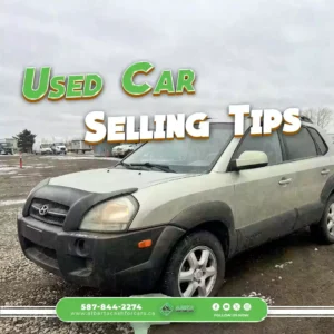Gray Hyundai SUV with black hood cover, parked on snowy lot, cloudy weather, Alberta Cash For Cars sign, contact 587-844-2274, green and white text.