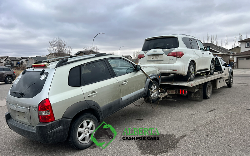 Accident damaged SUV loaded on a tow truck for cash car sale